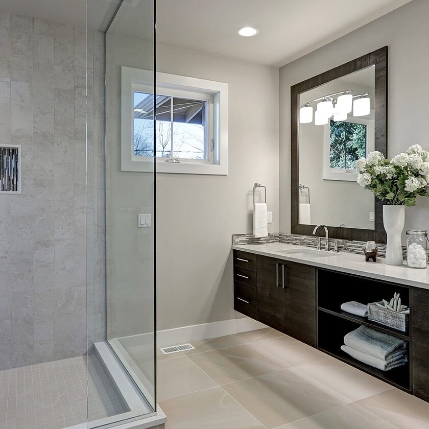 Modern bathroom interior with a large shower and double vanity.