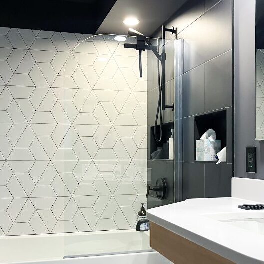 Modern bathroom interior with white sink and gray shower